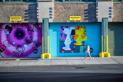 NEW YORK-MAY 24 - A girl walks past a street art display on a trucking garage in downtown Manhattan.