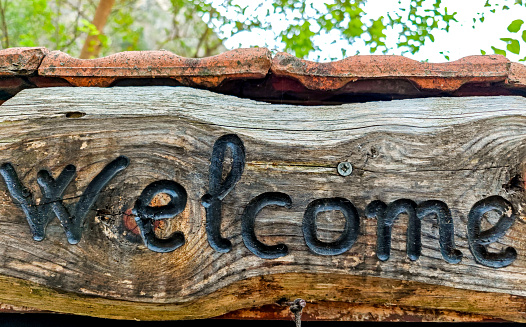Wooden sign with the message welcome