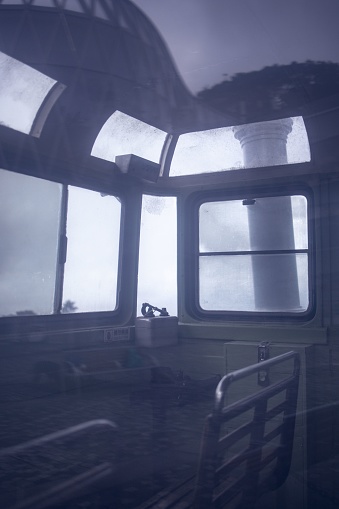 The interior of an abandoned train seen from a window