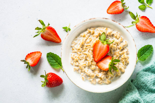 istock Oatmeal porridge with strawberry on white background. 1652668623