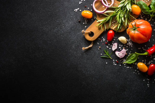 istock Food cooking background on black stone table. 1652670743