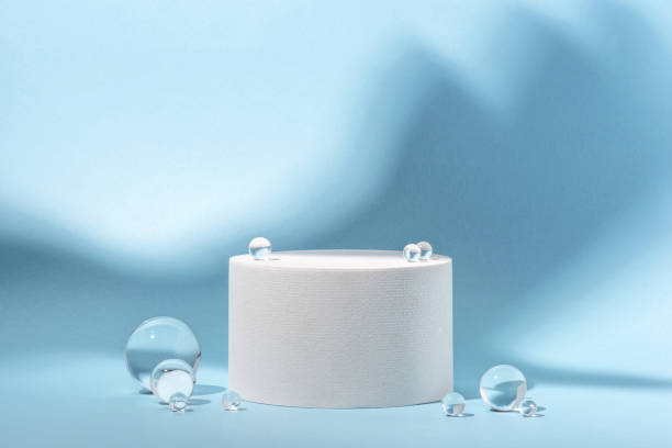 istock White podium with glass balls on a blue background. 1652674584