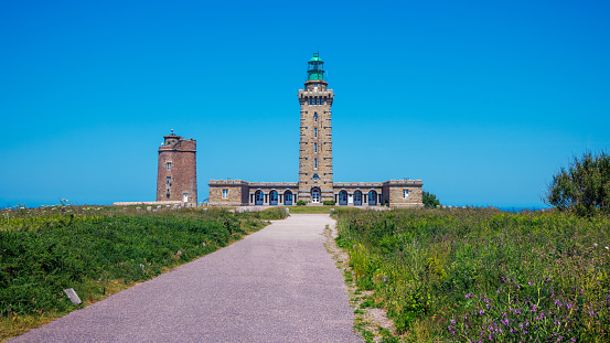 Beautiful sunset at the white lighthouse Lyngvid near Hive Sande in Denmark.