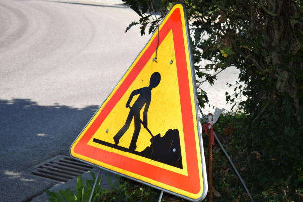 yellow and red road works sign