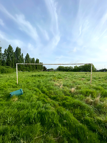 Goals and dustbin in an abandoned football pitch