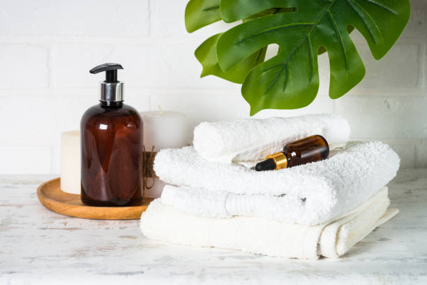 istock Bottle of soap and stack of towels in white bathroom. 1652712322