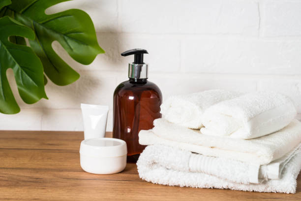 istock Bottle of soap and stack of towels in white bathroom. 1652712340