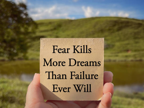 Motivational and inspirational wording. Fear Kills More Dreams Than Failure Ever Will written on a notepad. With blurred styled background. achievement aiming aspirations attitude stock pictures, royalty-free photos & images