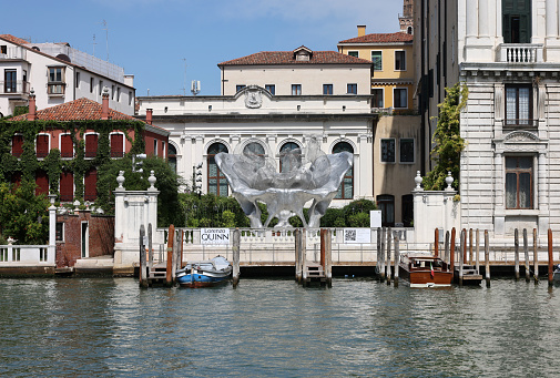 Venice, Italy - September 5, 2022: Baby 3.0 the monumental sculpture by Lorenzo Quinn in the garden of Ca Corner della Ca Granda palace in Venice.