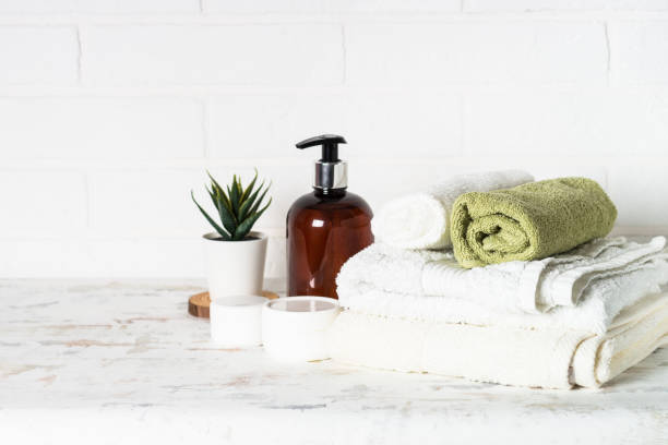istock Bottle of soap and stack of towels in white bathroom. 1652712883