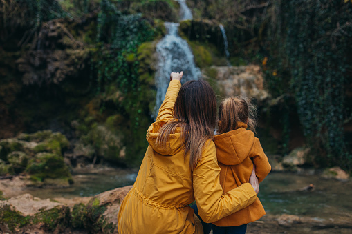 A beautiful scene of nature visitors in autumn wearing yellow raincoats.