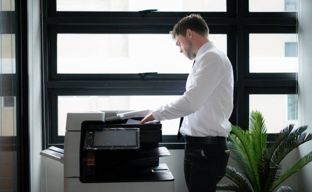 istock Businessman in office working with copier. 1652719647