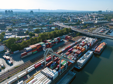 arial view on cargo container harbor and bridge behind in Mannheim at sunny morning, Mannheim has the second biggest inland harbor of europe