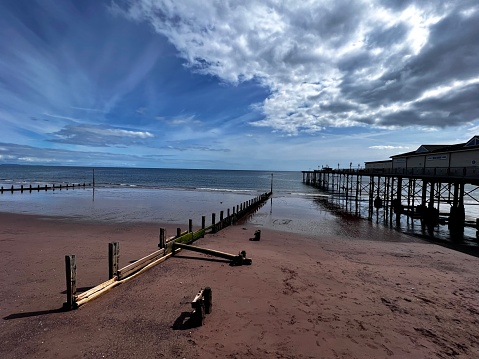 Deserted Teignmouth beach in September. Picture shows pier and groynes. Tide is going outwards