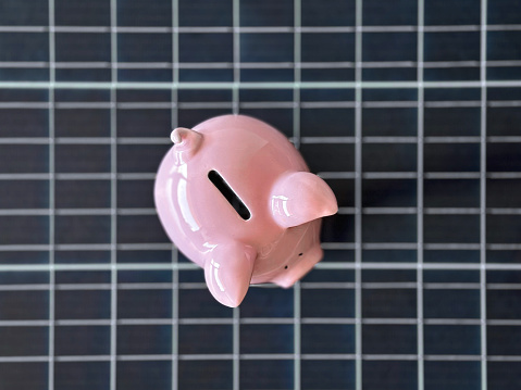 Piggy bank on a solar cell panel