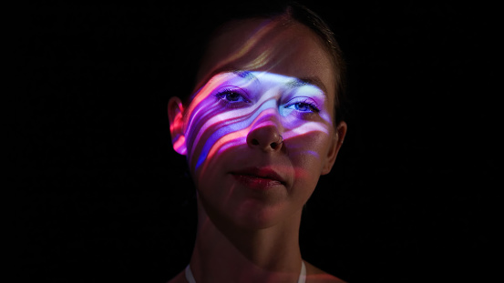 Neon lights on a woman's face.
