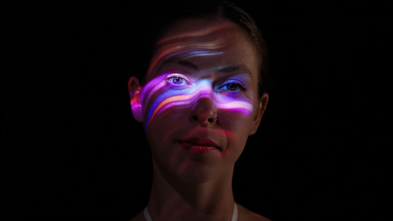 Neon lights on a woman's face.