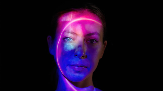 Neon lights on a woman's face.