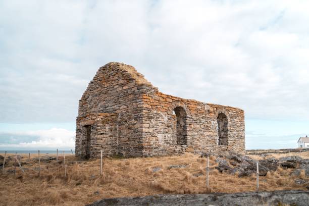 istock Idyllic rural scene featuring an old stone building situated in a lush dry grassy field 1652772277
