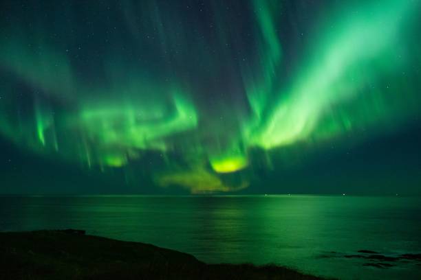 istock the aurora lights over water and land at night, from behind a cliff 1652773041