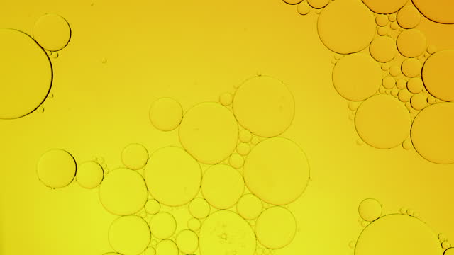 Macro shot, yellow gold bubbling oil round sphere water. Bubbles extreme close up. abstract smartphone home screen style, themes background, golden sphere, shaking vibrate exploding, energy source stock video