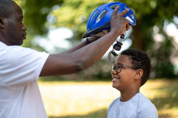 istock Dad fixing a protective hemlet on his kids head 1652804552
