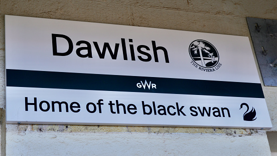 Dawlish, Devon, England UK - August 22nd 2023:  Sign at Dawlish train station for Great Western Railway identifying Dawlish as being the home of the back swan