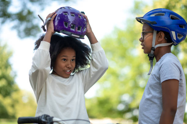 istock Siblings helping each other to put on a protective hemlet 1652805171