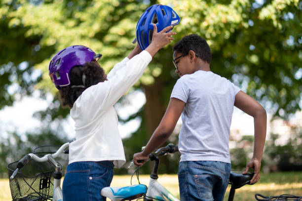 istock Siblings helping each other to put on a protective hemlet 1652805204