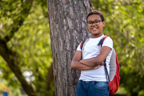 istock Dark-skinned boy in eyeglasses looking contented and happy 1652806346