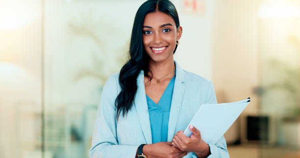 istock Happy, confident and successful businesswoman holding files while doing admin in an office. Female executive and entrepreneur ready to work with a positive attitude. HR manager ready to do interview 1652820093