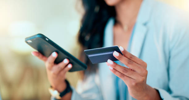 istock Bank card data put in phone by a lady who does internet banking by typing on her mobile to make an online credit payment. Young woman texting on her phone to send money via an ewallet transaction 1652820687