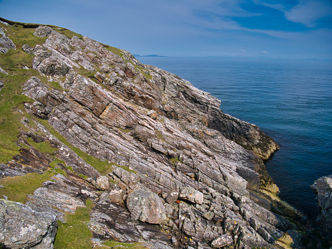 Inclined rock strata near the Eilean Glas Lighthouse on Scalpay - Outer Hebrides Thrust Zone Mylonites Complex - Mylonite. Metamorphic bedrock formed between the Archean Eon and Ediacaran periods.