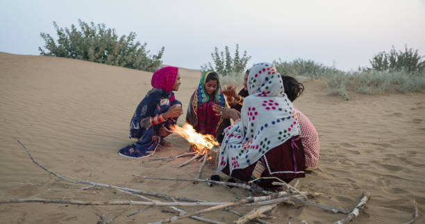 istock Indian kids setting up bonfire on sand dune 1652828278