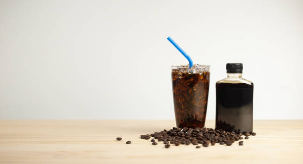istock Iced americano coffee with coffee beans on grey background, Black coffee glass package for takeaway. 1652835836