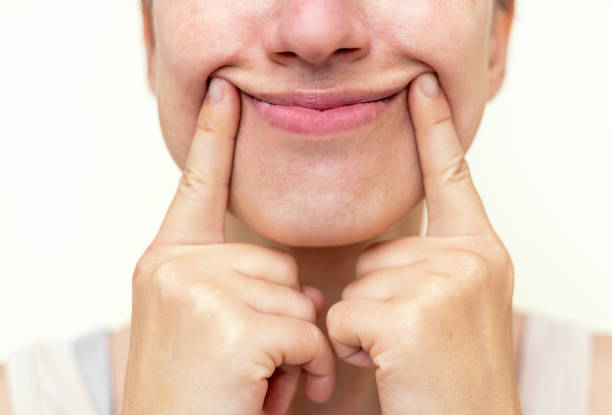 istock millennial woman practising face massage yoga exercises 1652842952