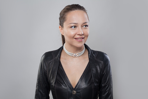 Choker with white pearl on neck of cheerful woman