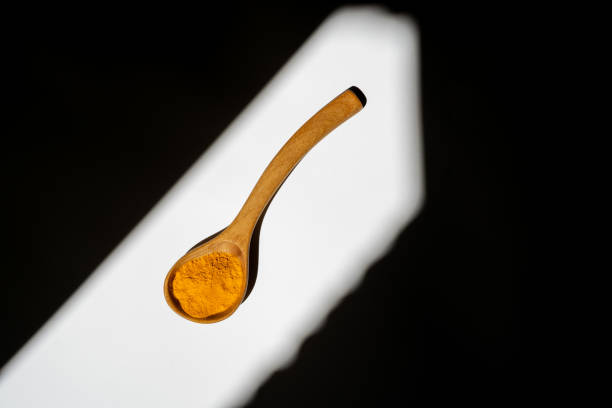 istock A wooden spoon with yellow turmeric. 1652845096