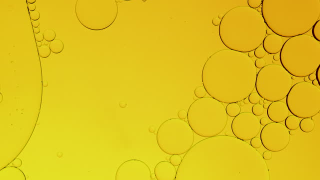 Macro shot, yellow gold bubbling oil round sphere water. Bubbles extreme close up. abstract smartphone home screen style, themes background, golden sphere, shaking vibrate exploding, energy source stock video
