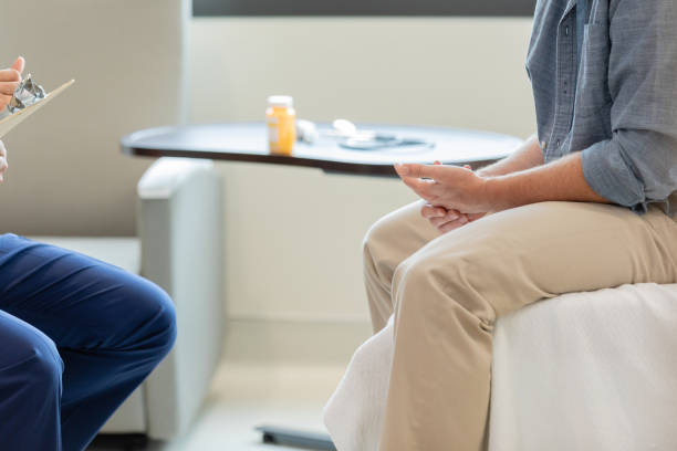 istock Low angle view male patient and male doctor talking 1652856464