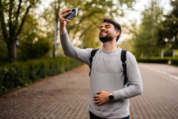 istock Man Taking Selfie With His Smartphone In The Park 1652858499