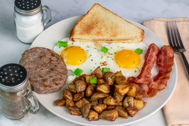 istock fried eggs served with bacon , sausageand homefries 1652901340