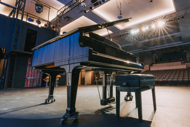 istock grand piano on stage facing empty theatre auditorium 1652902015