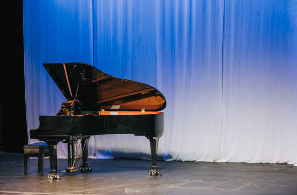 istock Music stage theater with grand piano and white backdrop illuminated with stage light 1652902047