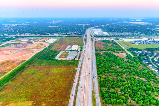 The Sam Houston Tollway through suburban south Houston about 10 miles from downtown shot from a helicopter at an altitude of about 600 feet at sunrise.