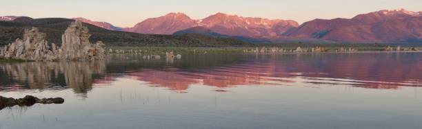 istock pink sierra nevada mountains and white tufa rock formations are reflected on the surface of mono lake at dawn. (wide angle) 1652915992
