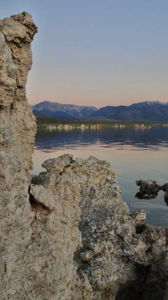 the sierra nevada mountains light up pink at dawn above the white tufa towers of mono lake. - mono county imagens e fotografias de stock