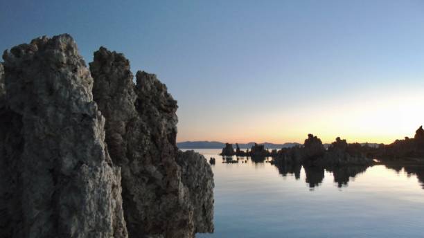 the iconic tufa rock formations of mono lake light up at dawn. - mono county imagens e fotografias de stock
