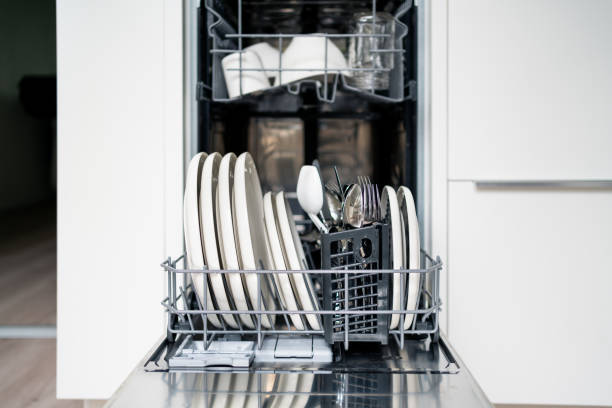 istock Dish washer machine. Washing plates and cutlery in basket. Open dishwasher in kitchen, front view. Full load of clean utensils and tableware. 1652927144