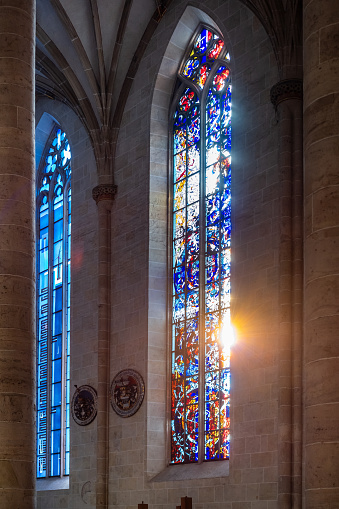 Bernardine church and monastery in Lviv, Ukraine. Church and fortification was built in 1600-1630. Beautiful stained glass window with sunlight. Religion and art concept.